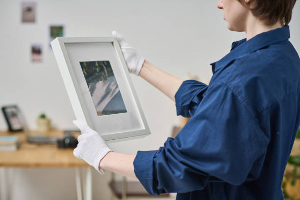 istock Photographer putting her photo in frame 1448995193