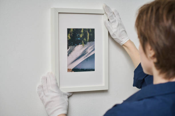 Woman decorating wall with framed photo