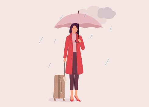 One Smiling Young Woman In Red Coat Holding Luggage And Umbrella On A Rainy Day With Dark Clouds. Isolated On Color Background.