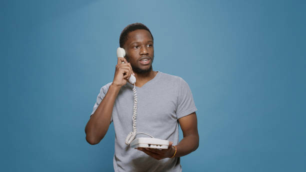 istock Young man answering landline phone call in studio 1448995821