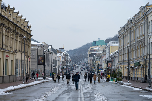 Kyiv, Ukraine - Decemember 13, 2022: Pedestrians walk on Petra Sahaidachnoho Street in the Podil district of Kyiv.