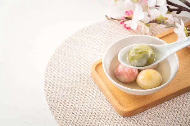 Photo of Colored glaze style big tangyuan with cherry blossom flower and syrup soup.