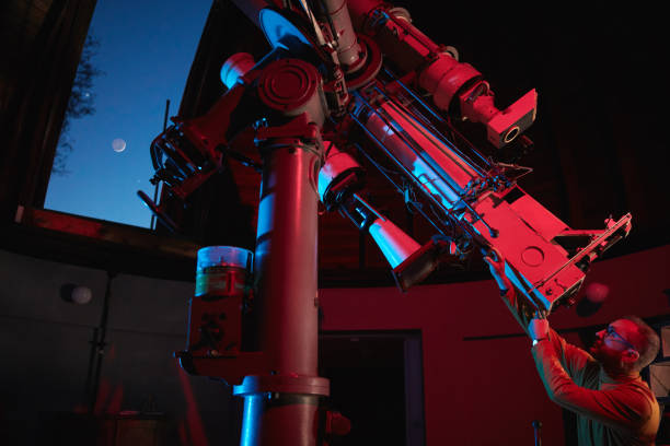 istock Astronomer with a big astronomical telescope in observatory doing science research of space and celestial objects. 1449007616