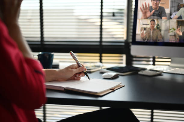 istock Cropped shot of young woman discussing issues remotely online via videoconference app on computer. 1449007719