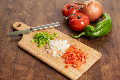 Tomatoes, peppers and onion, necessary ingredients to prepare a stir-fry.