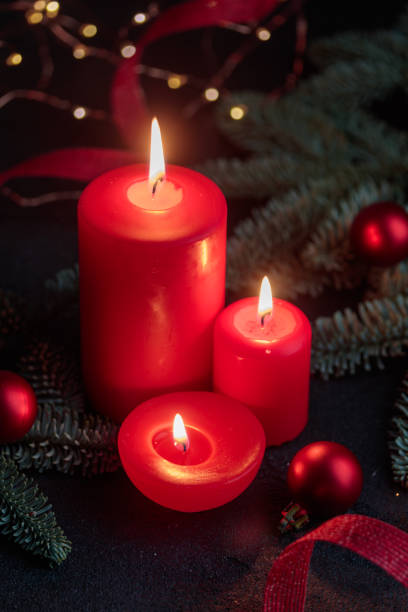 istock Red candles on dark background with christmas decoration 1449013068