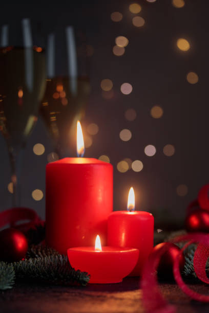 Red candles on dark background with bokeh lights Vertical with copyspace