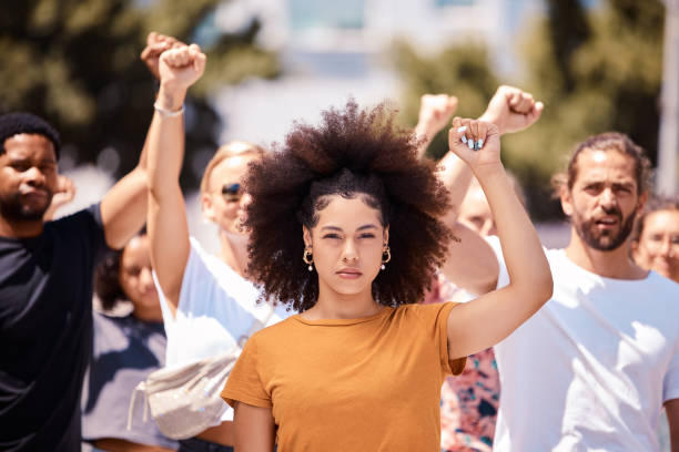 人々はロサンゼルスで自由のために抗議し、気候変動やブラックパワーのエンパワーメントを支持します。若い女性、将来の人権や世界革命のために戦うためにコミュニティが結集 - protest women marching street ストックフォトと画像