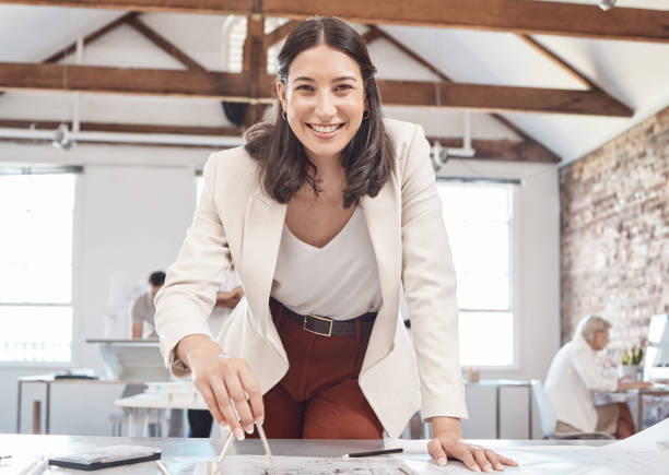 istock Architecture, young woman and designer planning, drawing and drafting blueprint, construction project and property building in startup agency. Portrait of engineer, creative and industrial floor plan 1449014537