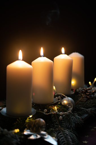A Scandinavian-style advent wreath, adorned with pristine purwle wax candles.