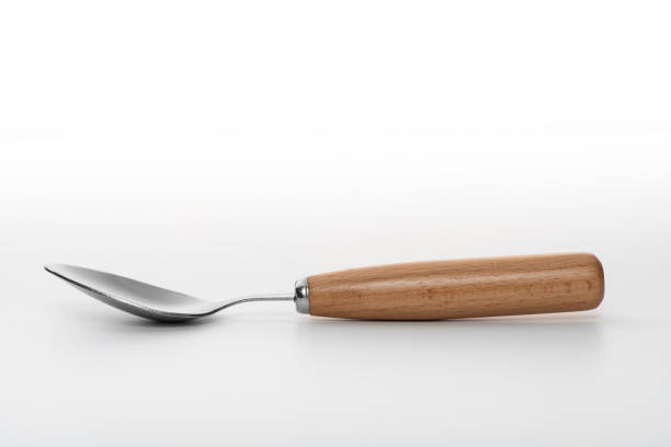 Wooden silver spoon isolated on white background.