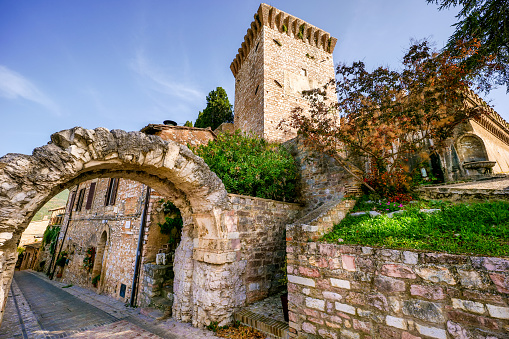 The Roman Arch and the Torre dei Cappuccini in the medieval village of Spello in Umbria