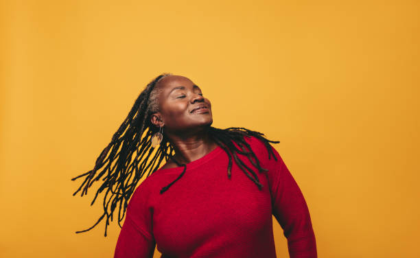 istock Beautiful black woman whipping her dreadlocks in a studio 1449020165