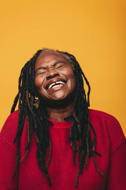 istock Happy black woman laughing cheerfully in a studio 1449020705