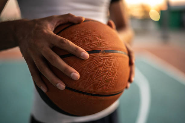 Close-up of man with basketball ball at sports field stock photo