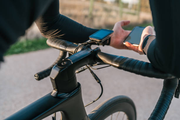 istock Hands of a cyclist dressed in black leaning on the handlebarx while consulting his location or the map on his mobile phone or synchronizing it with his cyclocomputer. 1449028149