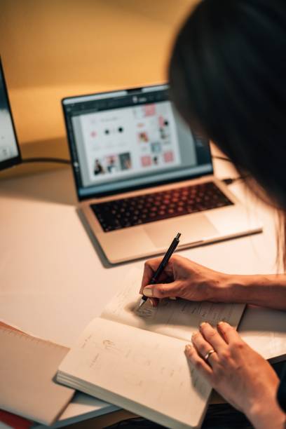 istock Vertical shot of a female drawing up designs in a notebook 1449030810