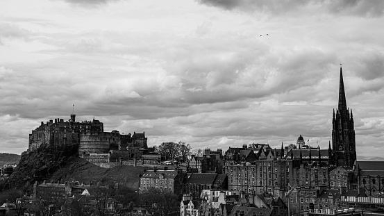 A grayscale of the ancient Edinburgh on a cloudy day