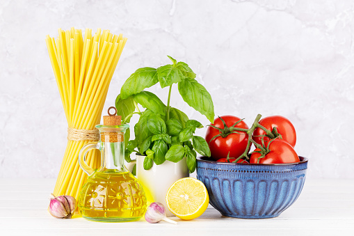 Ingredients for cooking. Italian cuisine. Pasta, tomatoes, basil