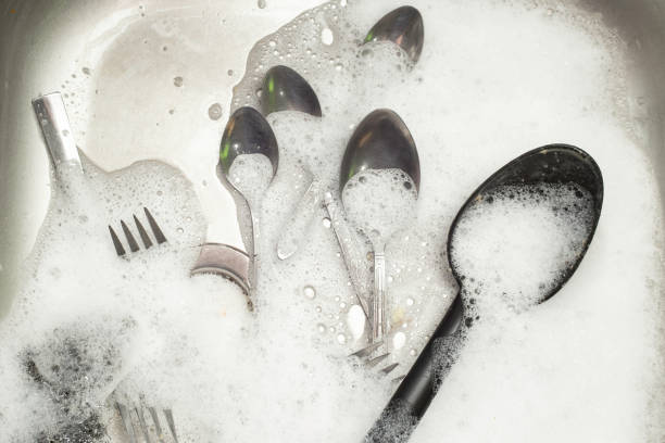 istock silverware covered in white foam in a steel sink 1449032580