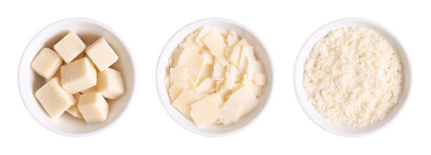 Grana Padano, Italian hard cheese, chunks, flakes and grated, in white bowls stock photo