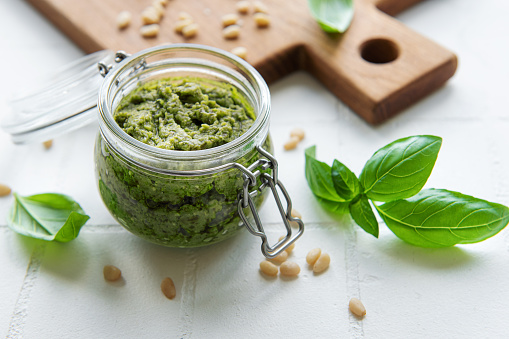 pesto sauce in a glass jar with clipping path.