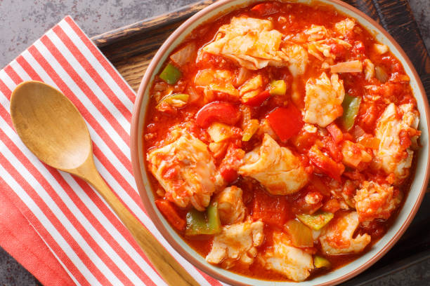 Bacalao al ajoarriero Cod with peppers and tomato sauce closeup on the bowl. Horizontal top view stock photo