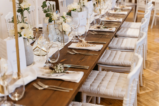 romantic wedding decoration with wooden chairs on rustic wooden table