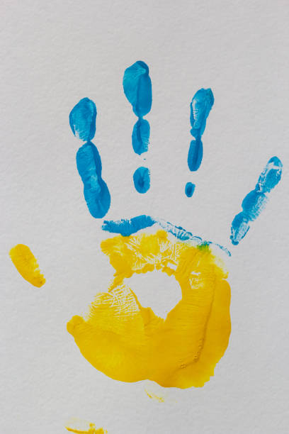 istock bright prints of children's hands from paint on the wall, background, texture 1449035969