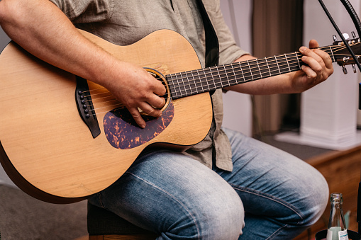 An electric guitar with red shiny body in dark environment and a lot of psace for additional content