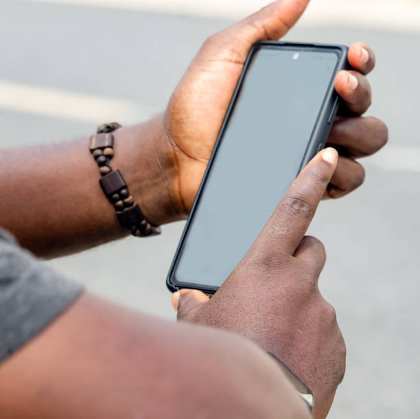 istock African man hands holding two smartphone with blank space screen for your texting or news content 1449036497