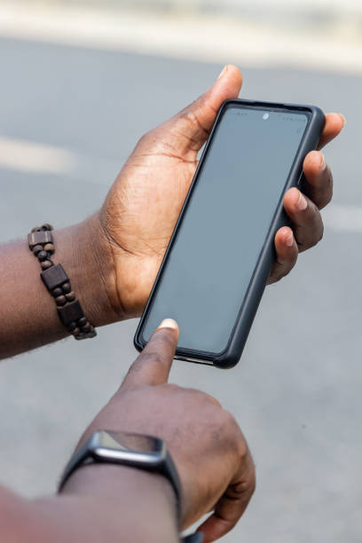 istock African man hands holding two smartphone with blank space screen for your texting or news content 1449036537