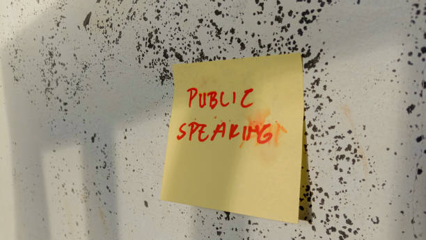 istock Text with the words public speaking on a note pasted on the wall 1449038545