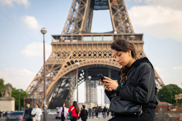 istock Young woman using smartphone in Paris 1449039377