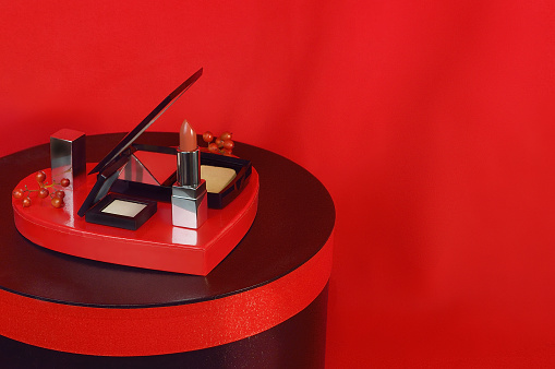 A Set of Cosmetics on the Red Background/Studio Shot