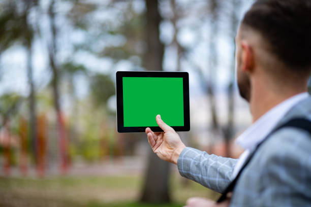 Man with tablet in park or outdoor
