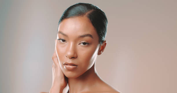 istock Studio shot of attractive woman touching her soft face 1449042024