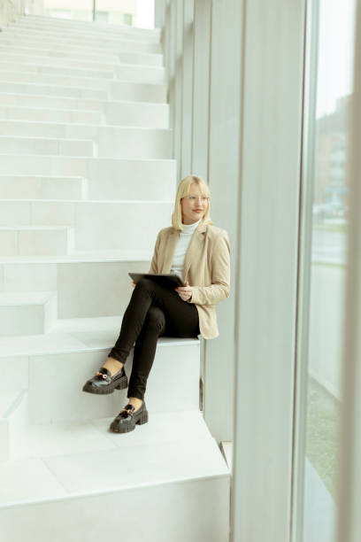 istock Businesswoman with digital tablet on modern office stairs 1449043165