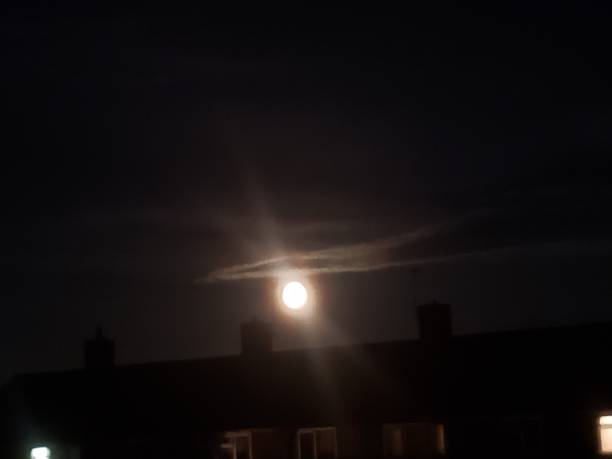 istock Stunning moon with a single cloud circling above the moon 1449044019