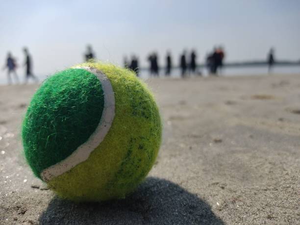 istock Tennis ball on the beach 1449047058