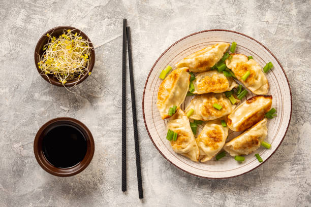 istock Gyoza, japanese pan-fried dumplings, on light background. 1449047063