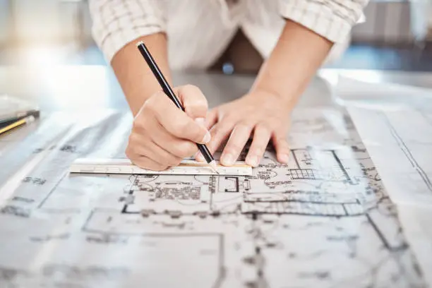 Photo of Architect drawing building floor plan, design blueprint map and engineer drafting structure on table paper. Real estate development work office construction and industrial wall safety ruler