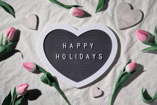 istock Spring natural flowers, hearts. Decorated heart shape text board, textboard with caption Happy Holidays. Pink tulips and painted wooden hearts. Easter, springtime flat lay Birthday, Spring holiday background, 1449062119