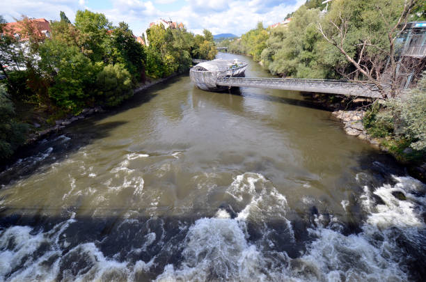 Graz, Austria - September 22, 2022: The so-called Murinsel was built on the occasion of the appointment as the cultural capital in 2003 and is located in the Mur river and connects both banks as a bridge
