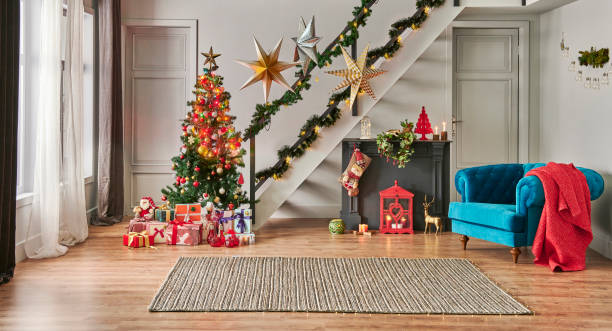istock Modern sofa Christmas New Year concept with pine tree gift box and fireplace, decorative led lamp, stairs and door background, grey wall, wicker carpet design. 1449063811