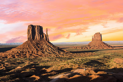 Beautiful sunset over the West and East Mitten Butte in Monument Valley. Utah, USA