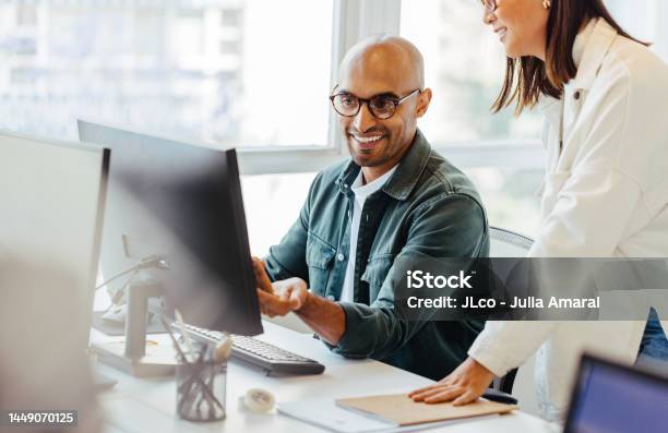 Software Engineers Using A Computer And Having A Discussion In An Office Stock Photo - Download Image Now