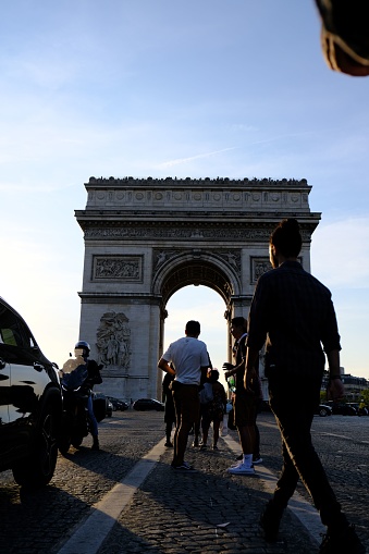 Paris, France – September 11, 2022: A vertical shot of a crowd of people near the historic Arc de Triomphe in Paris, France