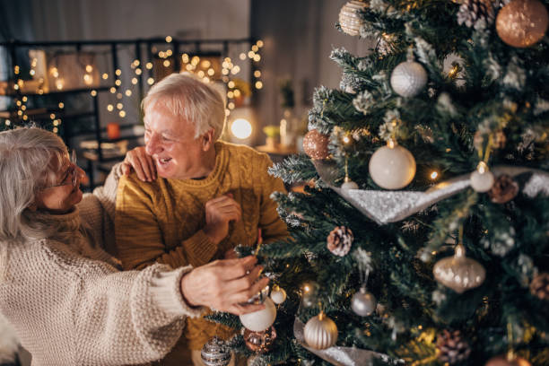 istock Senior couple decorating Christmas tree at home 1449079884