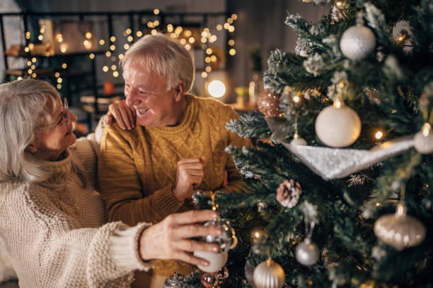 istock Senior couple decorating Christmas tree at home 1449081525